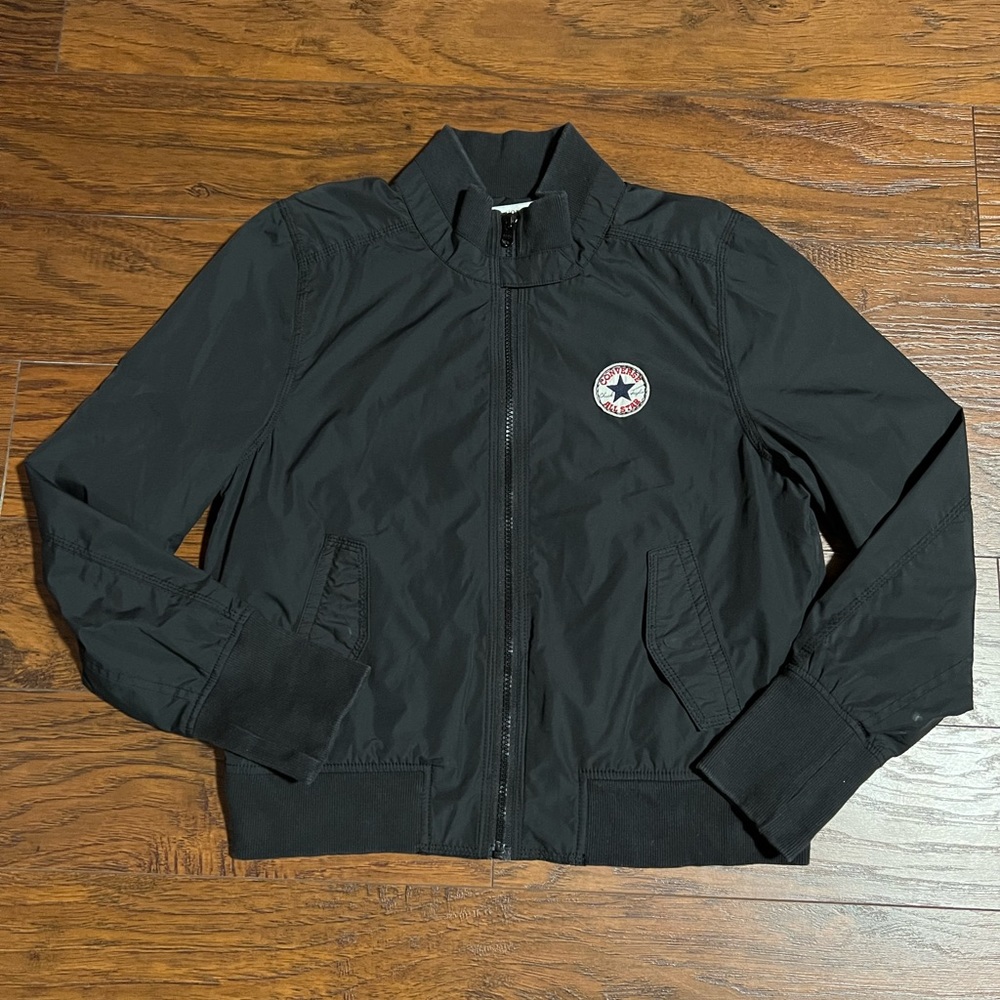 Black bomber jacket with gray cloth lining.